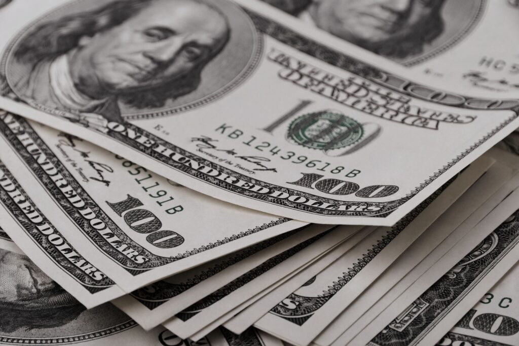 Is Your P&L Missing This? How One Real Estate Team’s Profitability Was Buried Under $140K in Waste Stack of $100 bills representing financial clarity and improved real estate team's profitability.